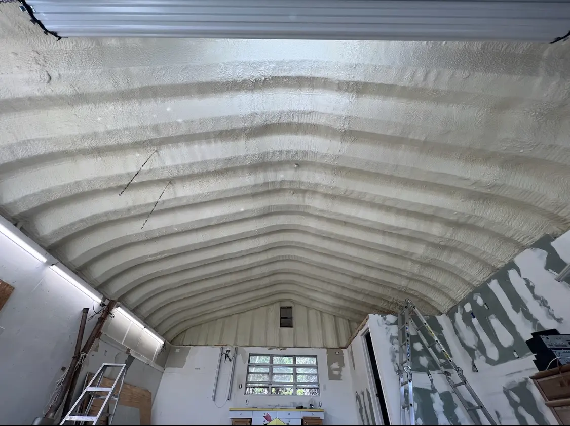 Spray polyurethane foam applied to the underside of a metal roof deck in St. Robert